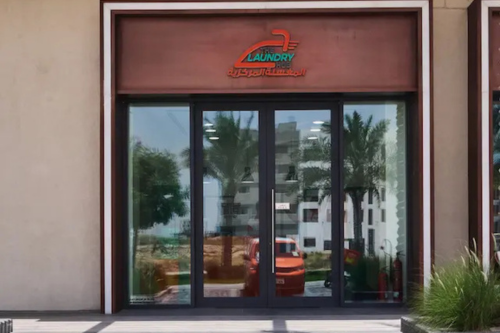 The Laundry Hub storefront entrance with glass doors