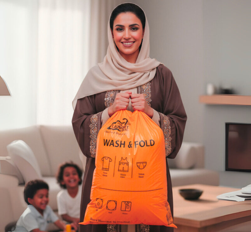Smiling customer holding The Laundry Hub laundry bag